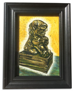 glowing foo dog with gold background rendered in scratchboard by Lori McAdams in a black frame