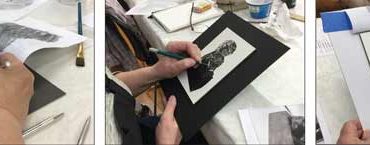 three artists each drawing a black and white foo dog in scratchboard.