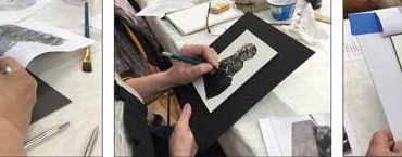 three artists each drawing a black and white foo dog in scratchboard.