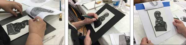 three artists each drawing a black and white foo dog in scratchboard.