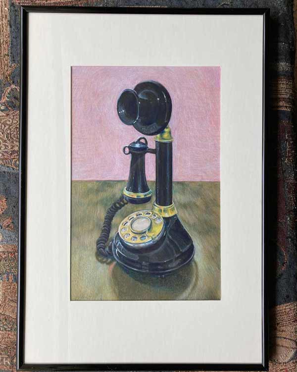 Framed drawing of a black old candlestick-style black rotary phone with golden dial and accents aginst a wooedn table and pink background.