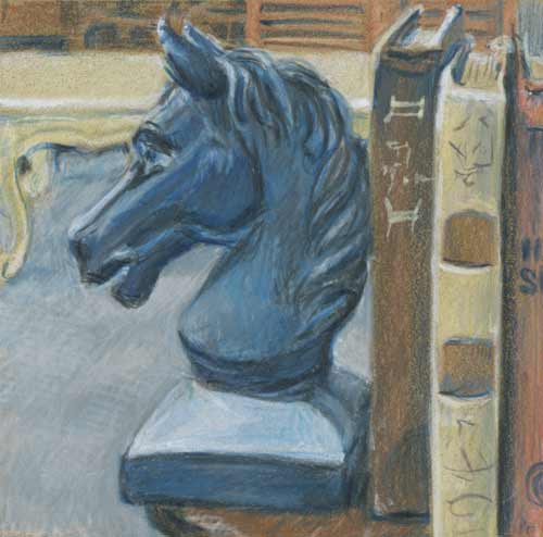Blue-black horse head bookend with books.