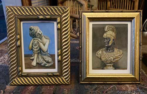 two framed artworks - buddha stature and roman bookend.