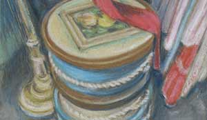 three stacked round hat boxes among vintage clothing.